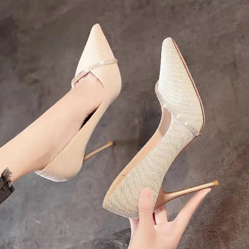 Women's black and gold stiletto high heels with pointed toe design and low-cut silhouette