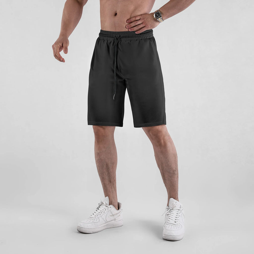Man wearing black loose-fit quick-dry mesh shorts with an elasticated waistband.