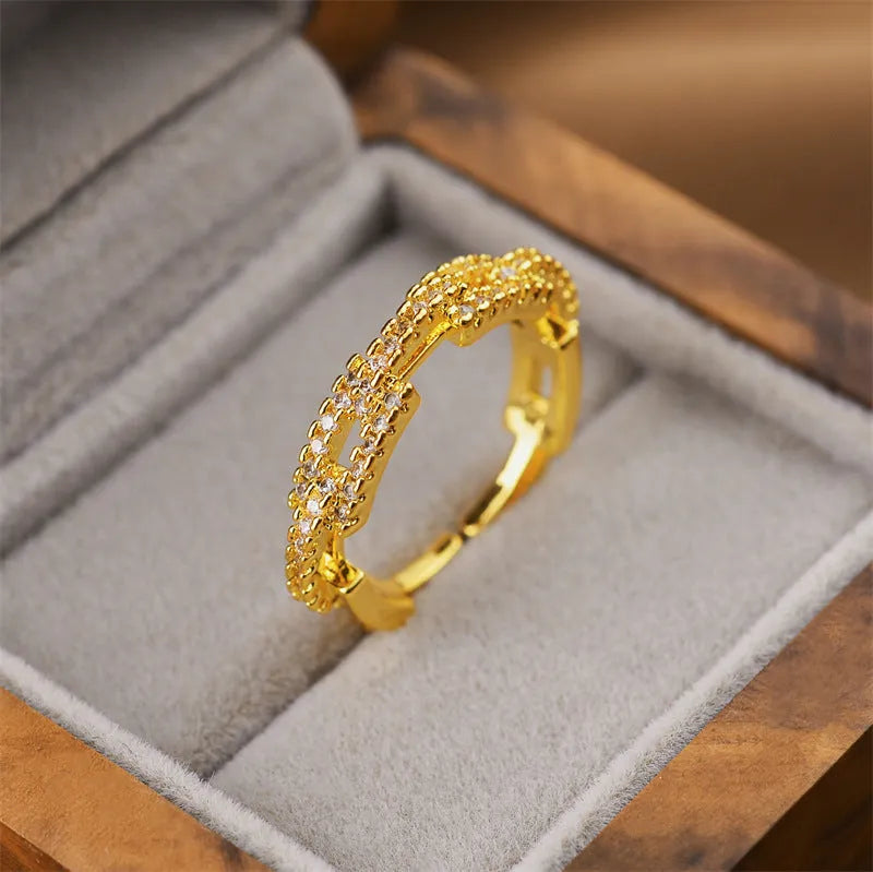 Gold coloured open geometric women's ring on a copper base, showing Korean fashion style.