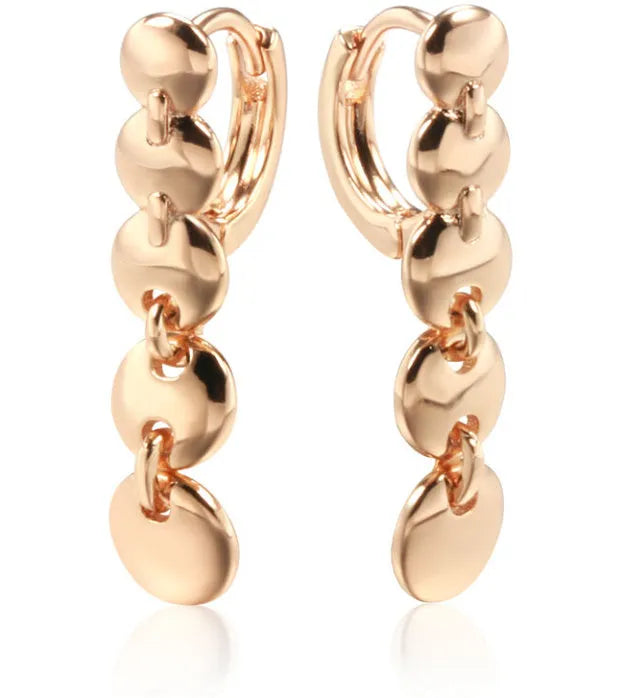 Gold-coloured retro woven round copper earrings showing textured circle design.
