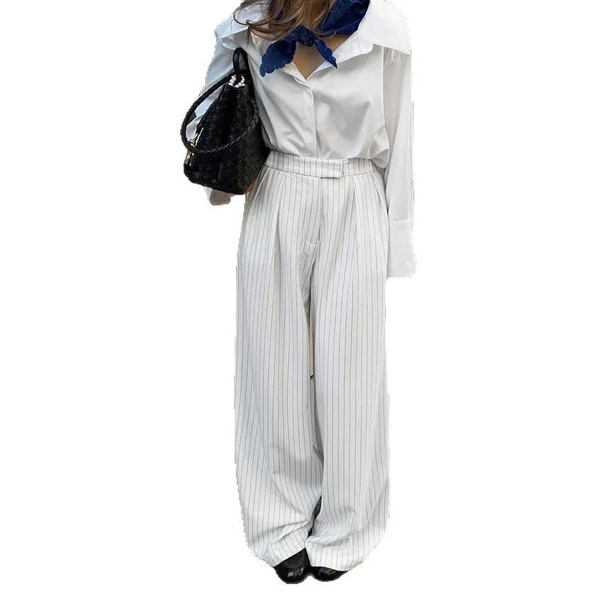 White striped wide-leg commuting trousers with zipper closure on mannequin