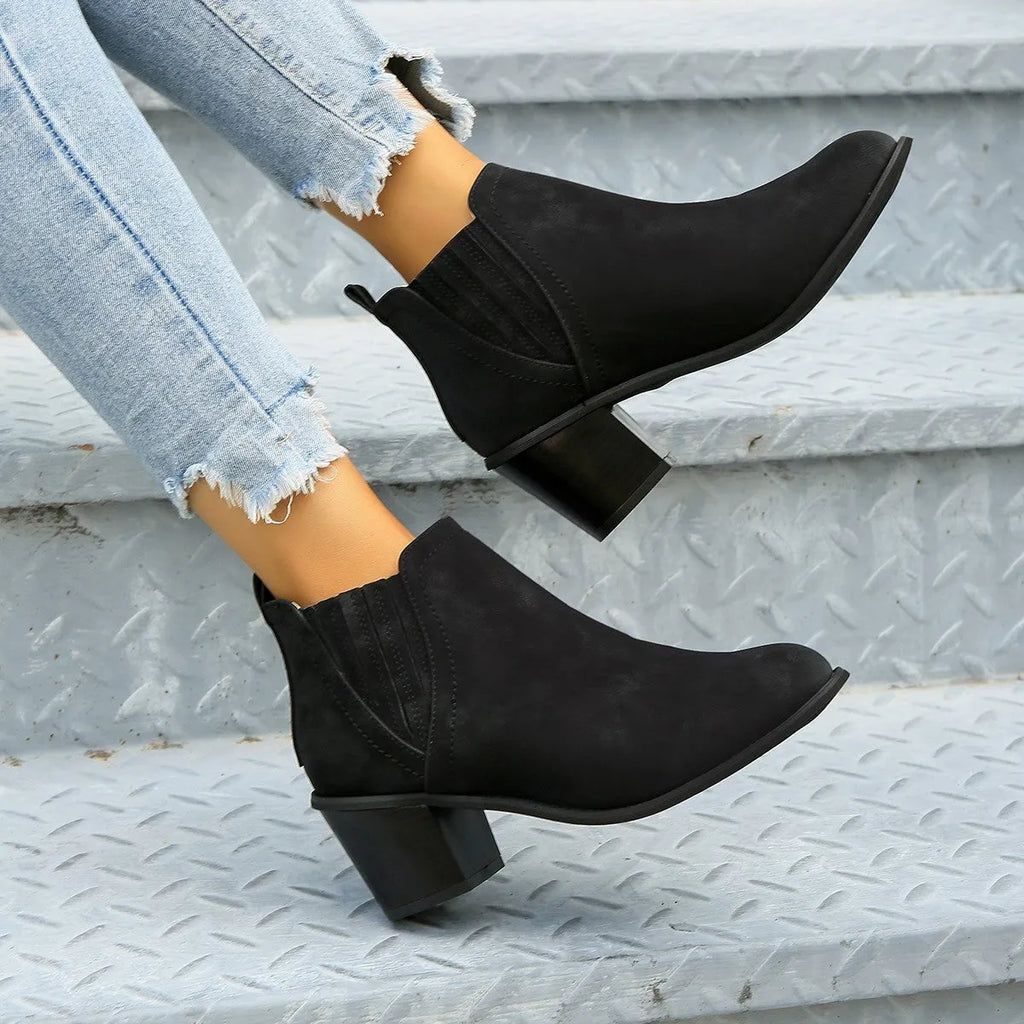 Women's black pointed toe ankle boots with a thick square low heel, made of artificial PU.