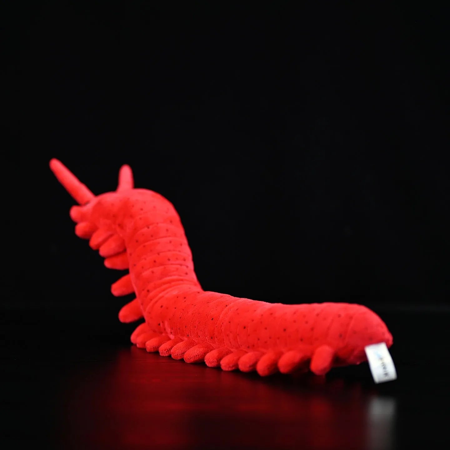 Red velvet worm plush toy silkworm doll 60cm long on a plain background