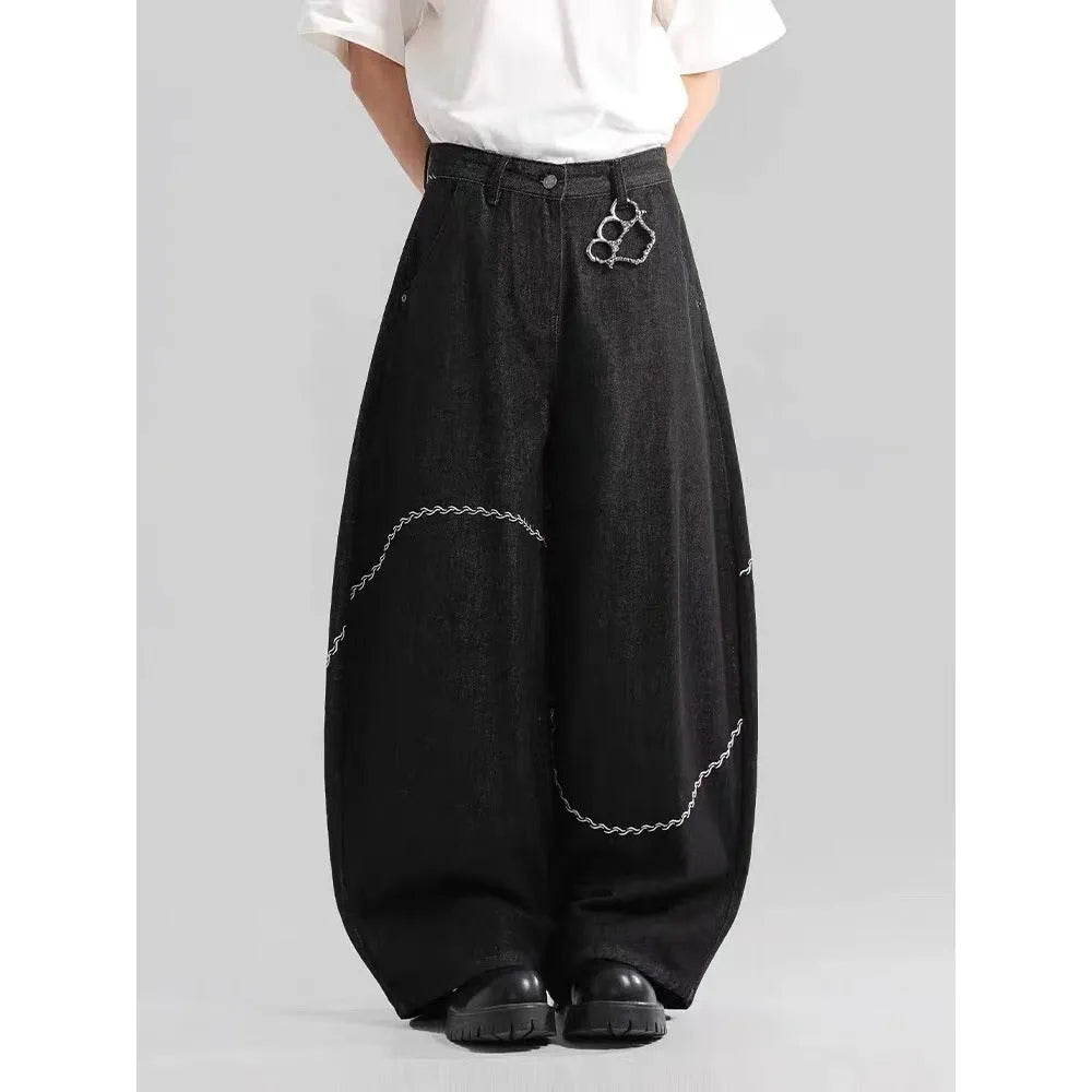 Black straight-leg denim trousers with a mid-waist fit and zip fly, laid flat.