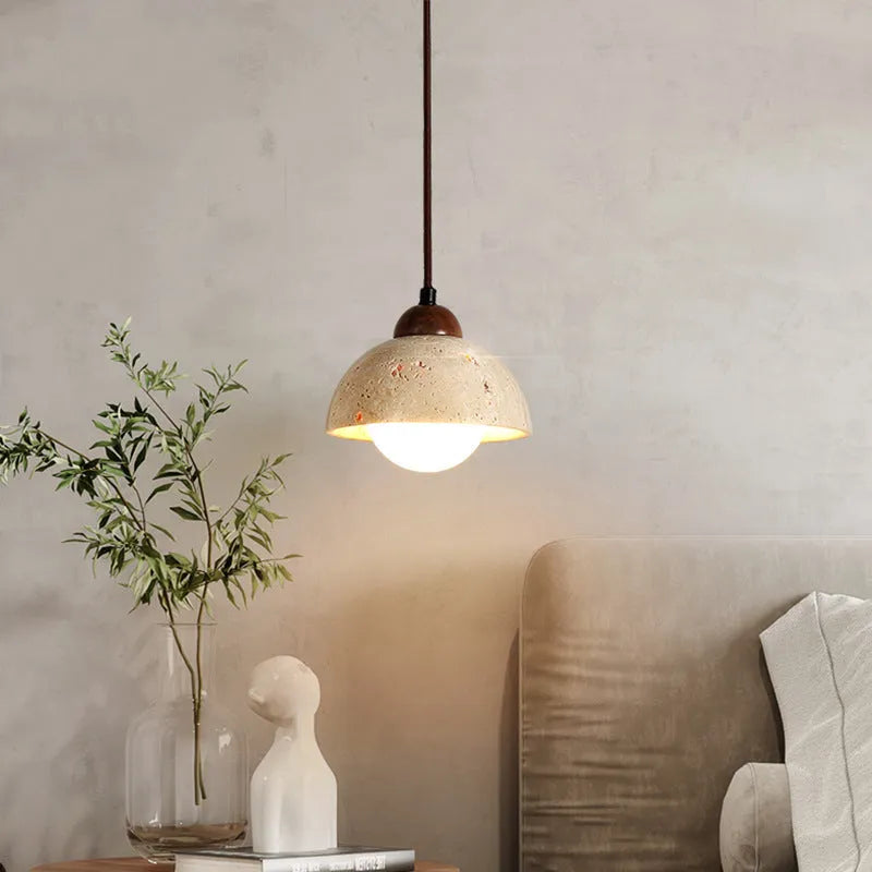 Yellow cave stone wabi sabi style marble bedside pendant light on a wooden surface
