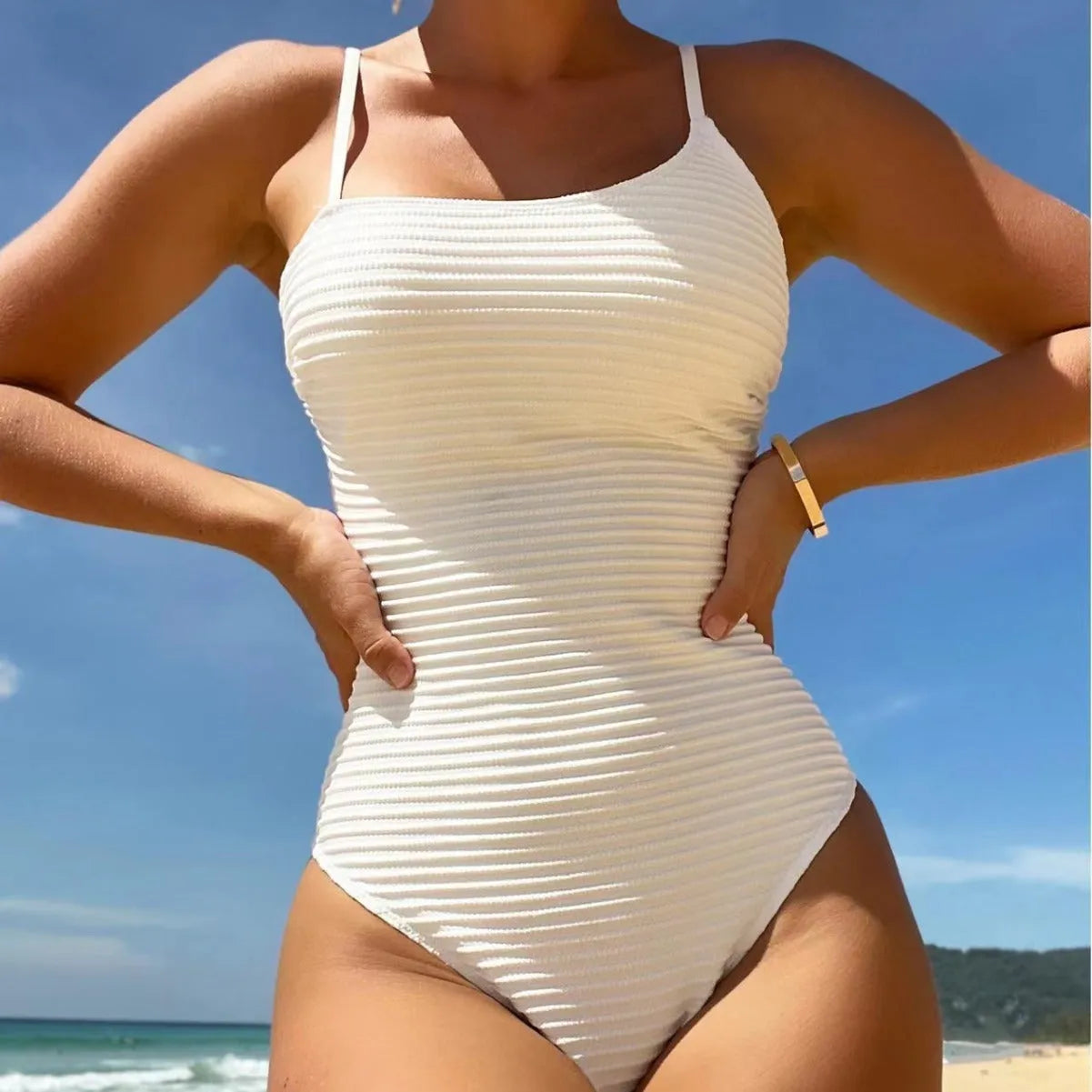 Conservative slim-fit one-piece swimsuit with spaghetti straps in a solid colour.