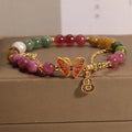 Women's tourmaline butterfly gourd bracelet with agate, showing jade coloured carved centrepiece.