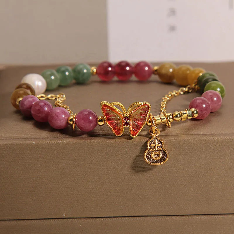 Women's tourmaline butterfly gourd bracelet with agate, showing jade coloured carved centrepiece.