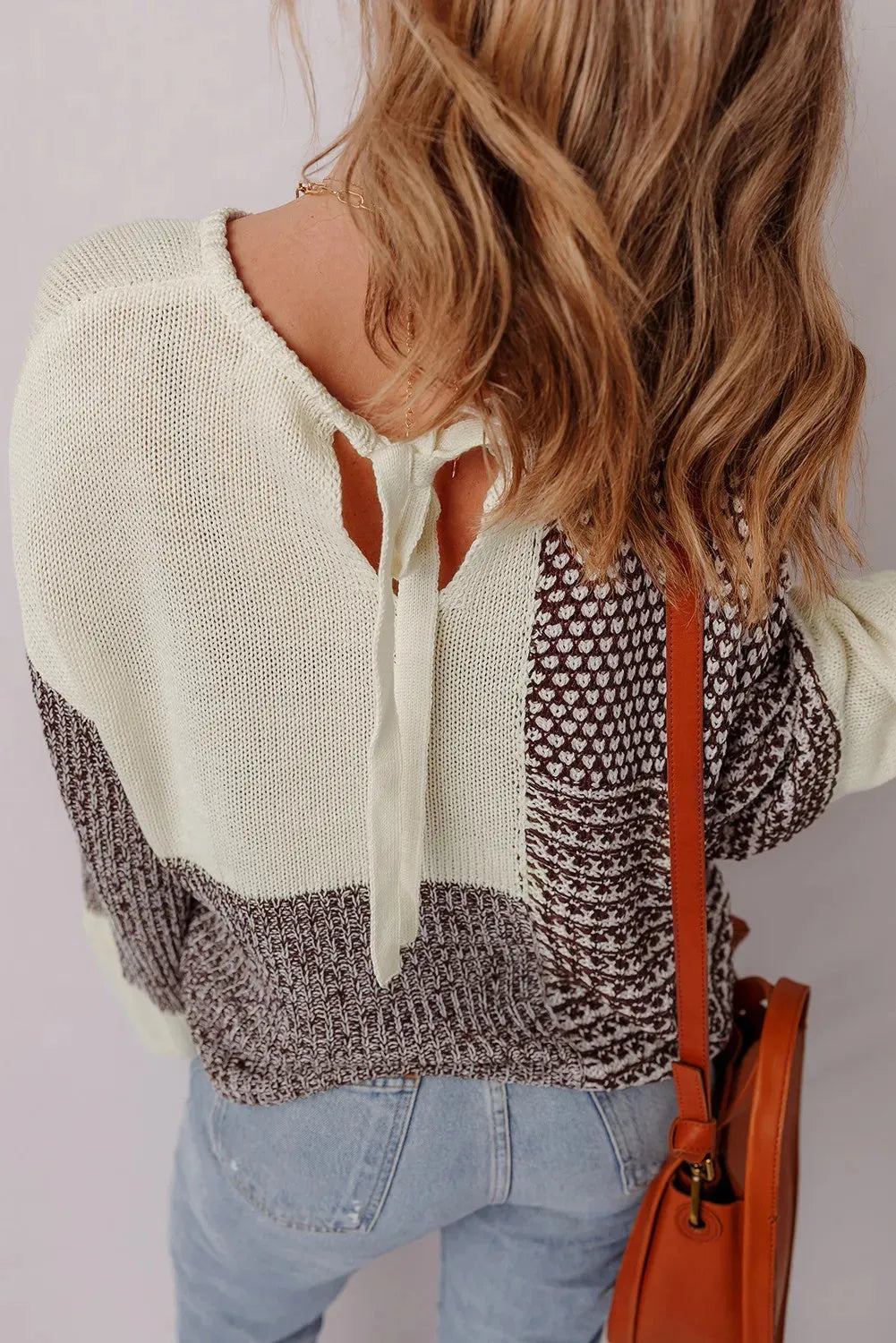 Dark khaki colour block women's loose knit sweater with a back tie and drop shoulders.