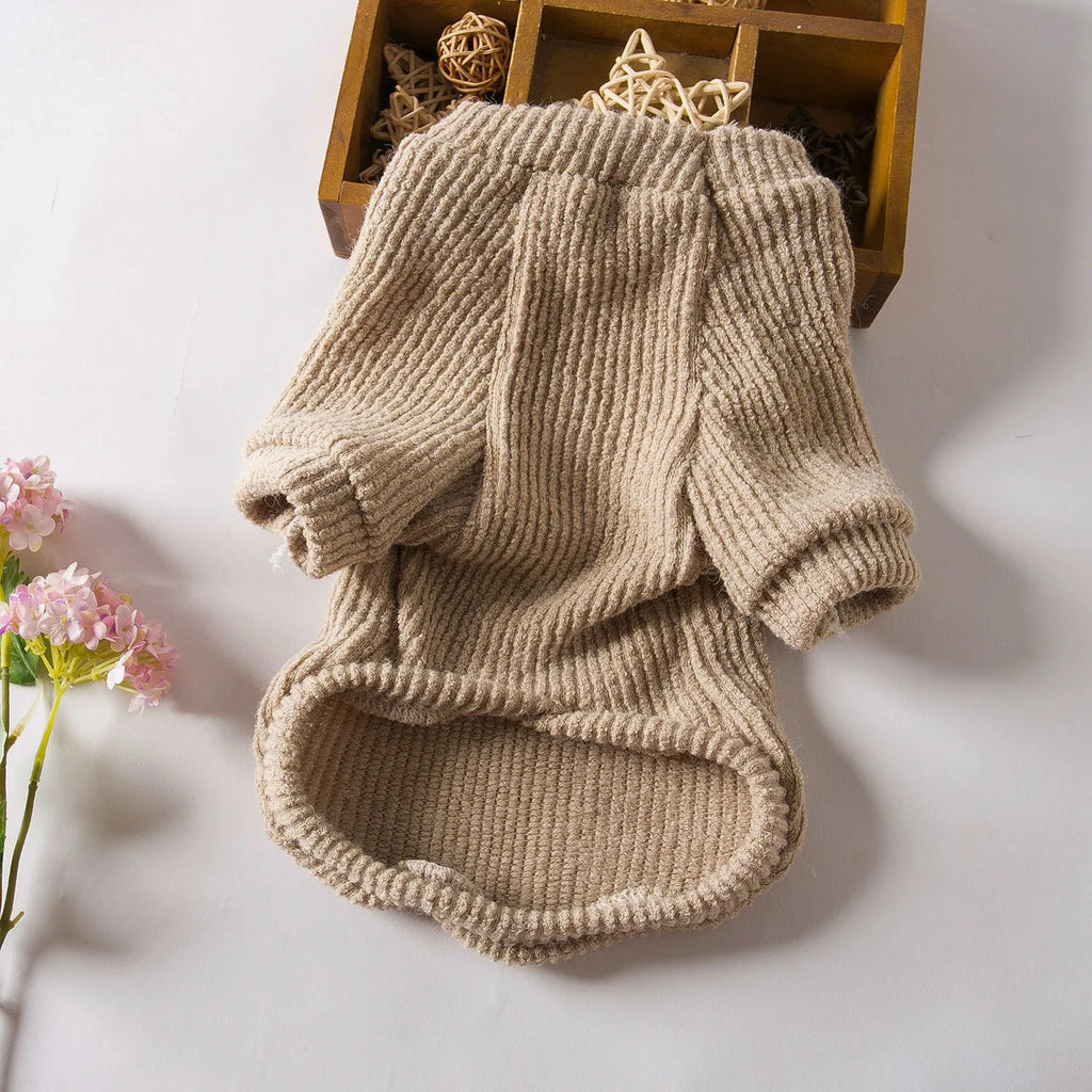 A brown knitted pullover sweater for a small dog on a mannequin.
