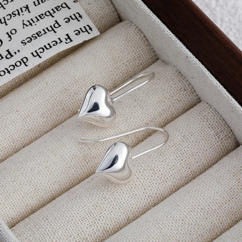 Three-dimensional glossy heart earrings with Korean style design in silver tone