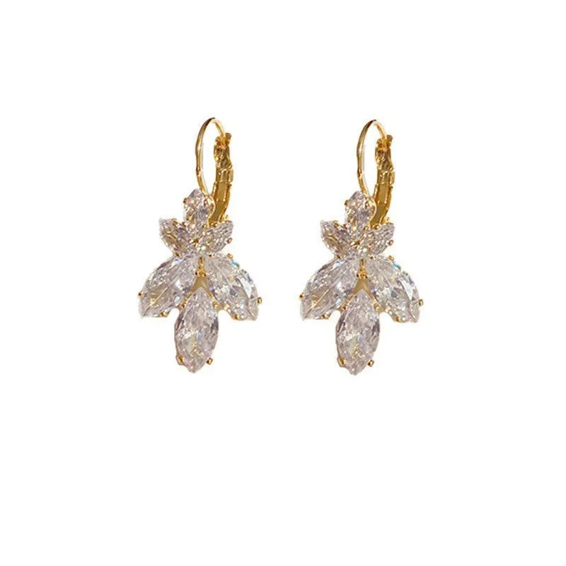 Platinum colour leaf-shaped earrings with zircon inlay creating shiny reflective surfaces