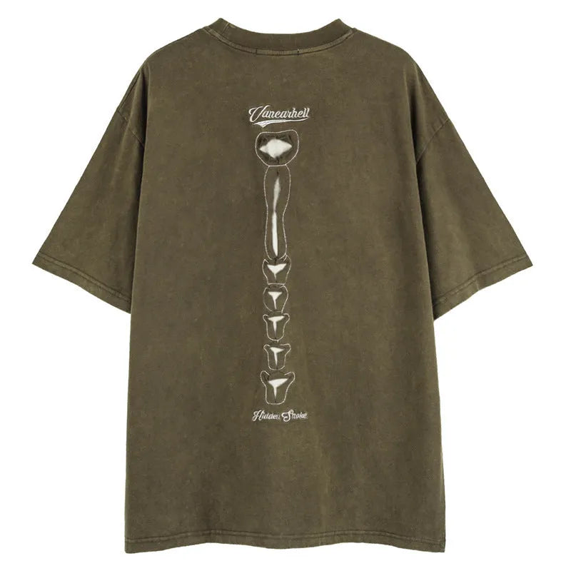 A man's black loose-fit cotton t-shirt with a skull and letter graphic print and drop-shoulder sleeves.