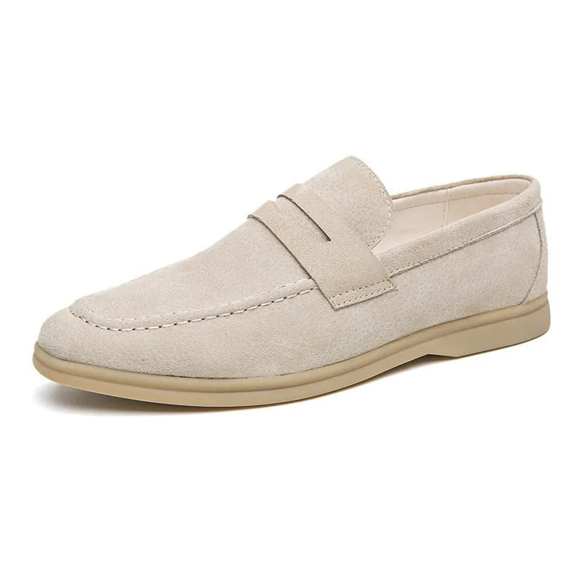 Men's beige leather slip-on casual shoes with a round toe and rubber sole on a white background.
