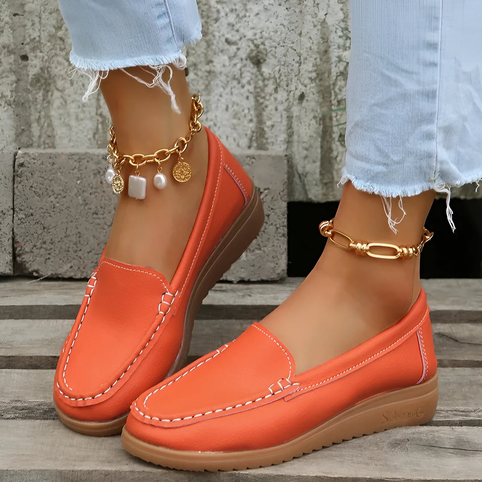 Women's flat loafer shoe in PU leather with car suture detail and a round toe, shown in a choice of colours.