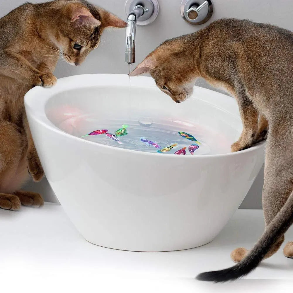 Electric swimming fish toy with LED lights and moving fins, 7.5cm plastic body, available in 8 colours, for pets and babies.