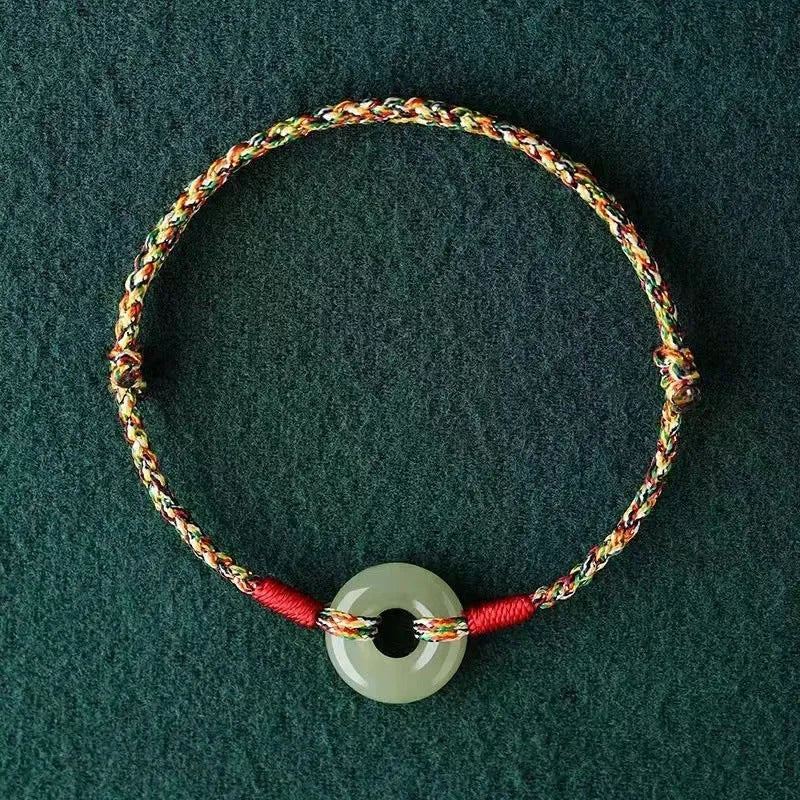 Colourful woven rope bracelet with peace buckle closure on wrist