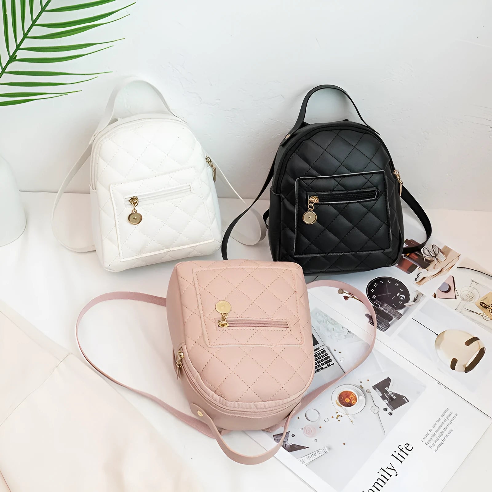 Girls' hard square PU backpack with embroidery in pink, showing front sandwich pocket and carry handle.