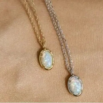 S925 sterling silver necklace with a geometric pendant holding a round jelly opal, plated in gold.