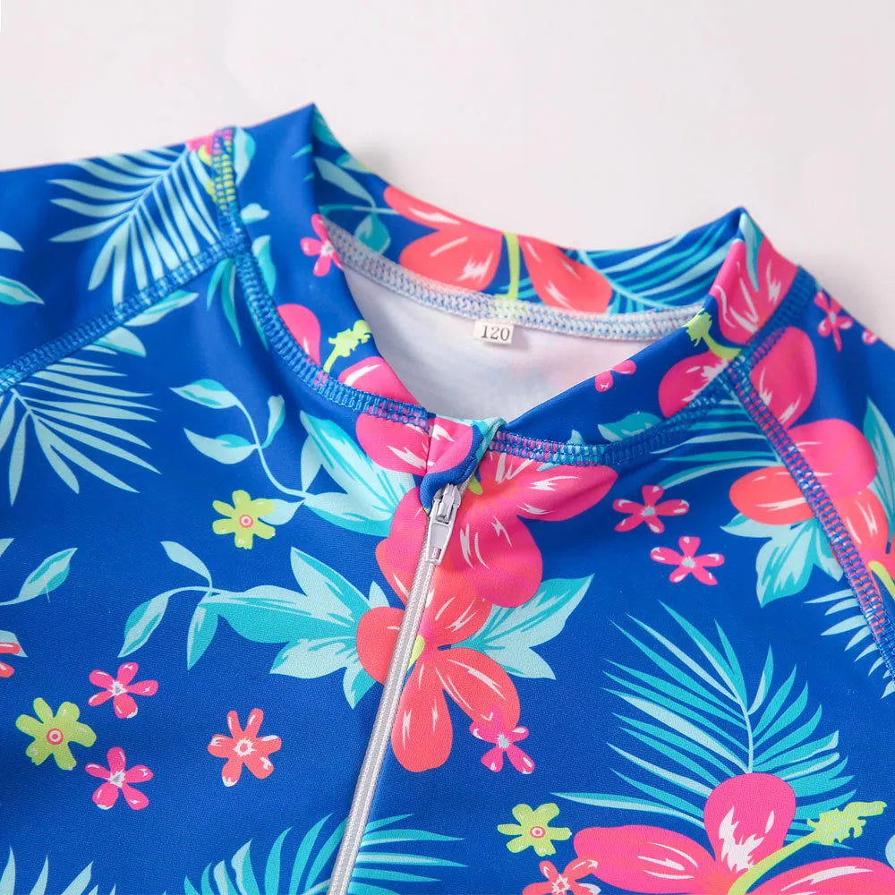 Girl's long-sleeve one-piece swimming suit in polyester fabric on a mannequin, showing briefs style.