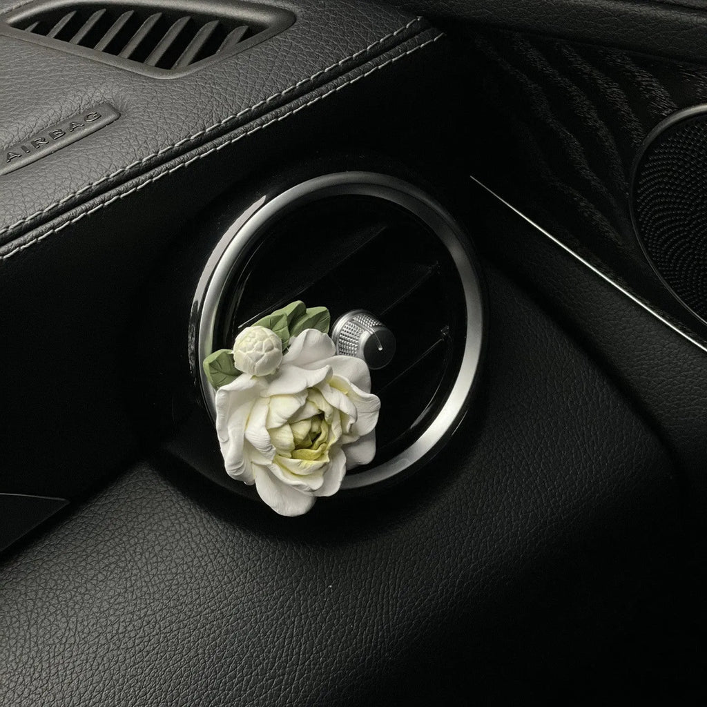 Jasmine-scented gypsum car air freshener ornament in off white or green, shown next to a 5ml essential oil bottle.