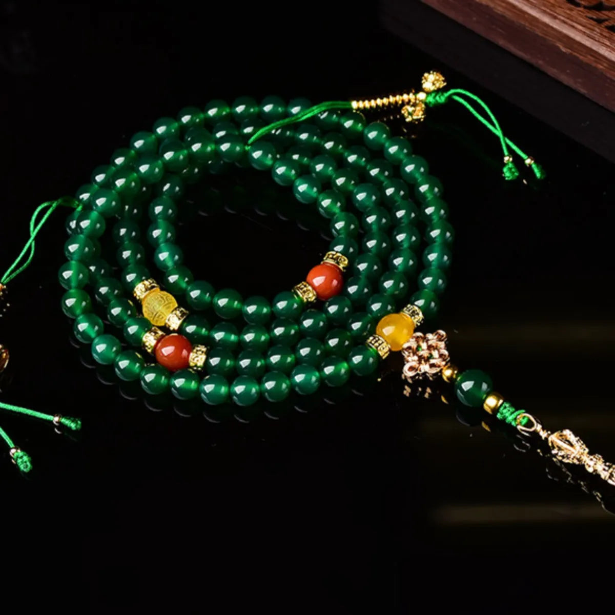 Close-up of a multi-circle green agate bracelet with natural stone beads on a wrist.