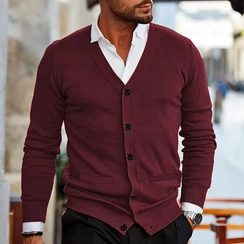 Men's slim fit acrylic cardigan sweater in dark grey, hanging on a hanger.