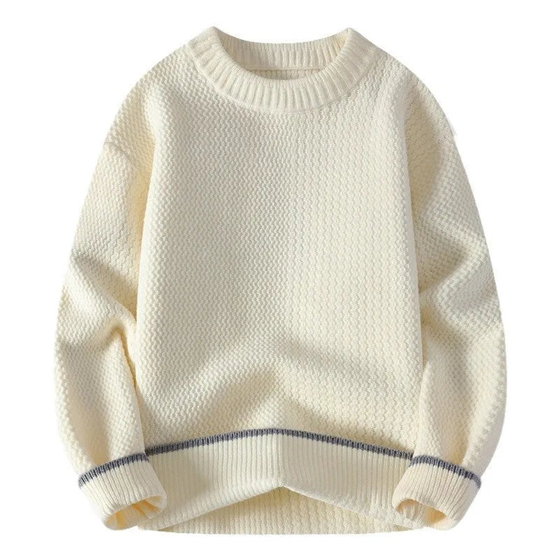 Man wearing a grey loose fit round neck long sleeve pullover sweater
