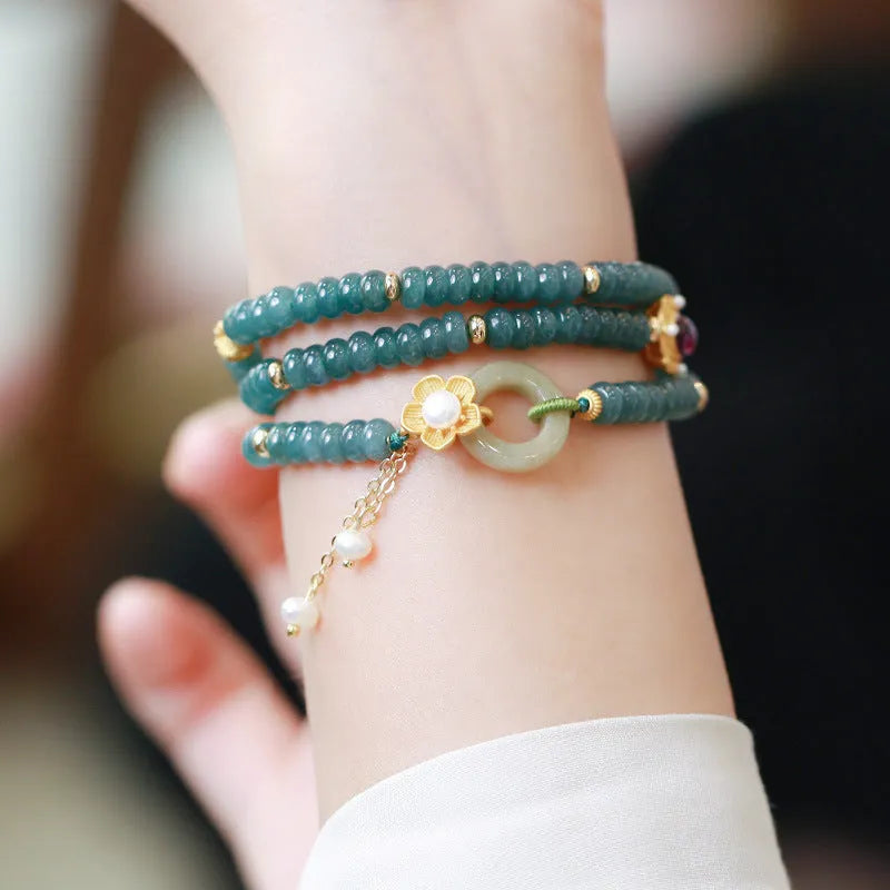Blue water abacus and jade bead bracelet with tourmaline pearls in a three-ring design.