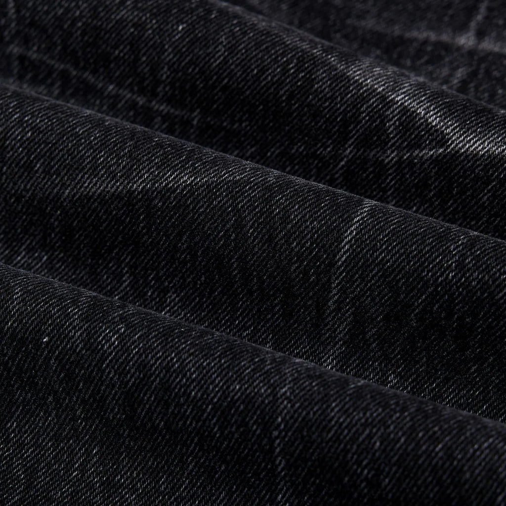 Black straight-leg men's jeans with a distressed lightning crack pattern on the legs.