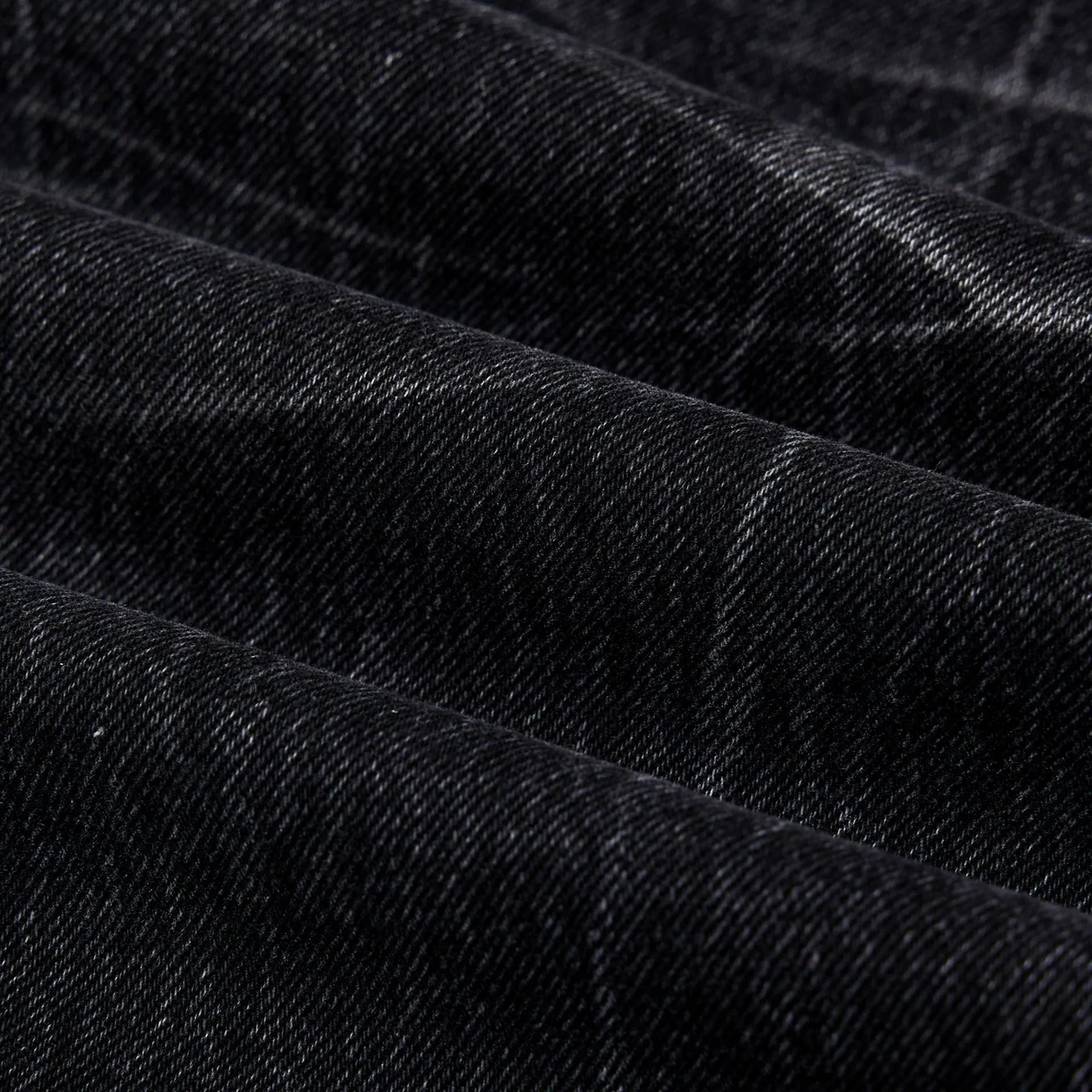 Black straight-leg men's jeans with a distressed lightning crack pattern on the legs.