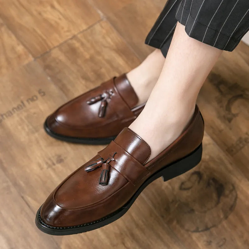 Men's black slip-on business casual shoes with tassel detailing and rubber sole