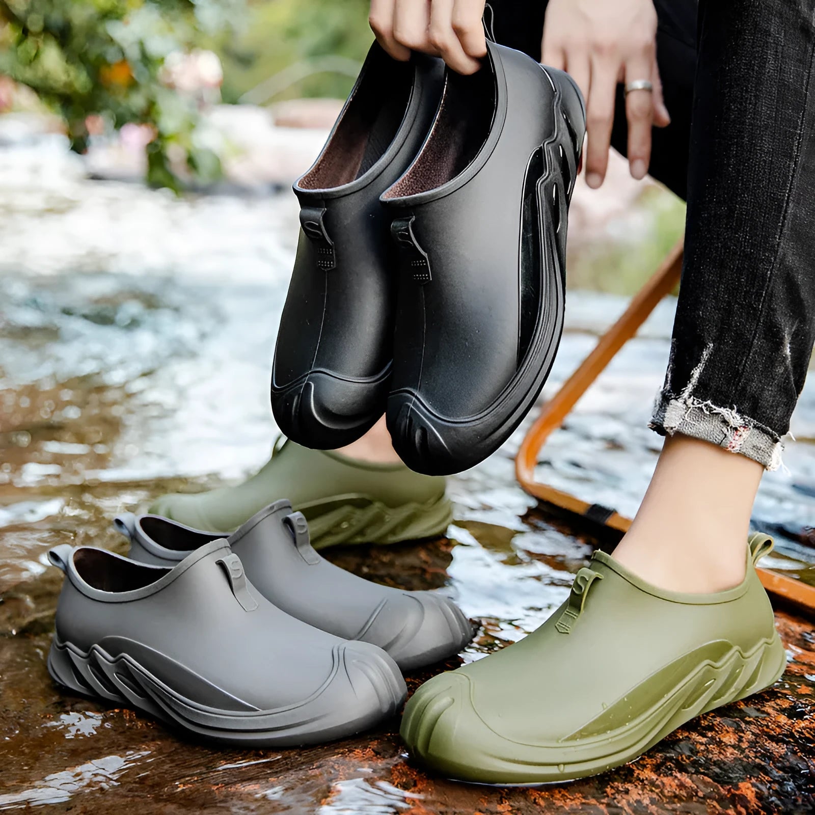 Men's short black plastic rain boots shown in a casual setting
