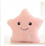Colourful glowing five-pointed star plush pillow on dark background