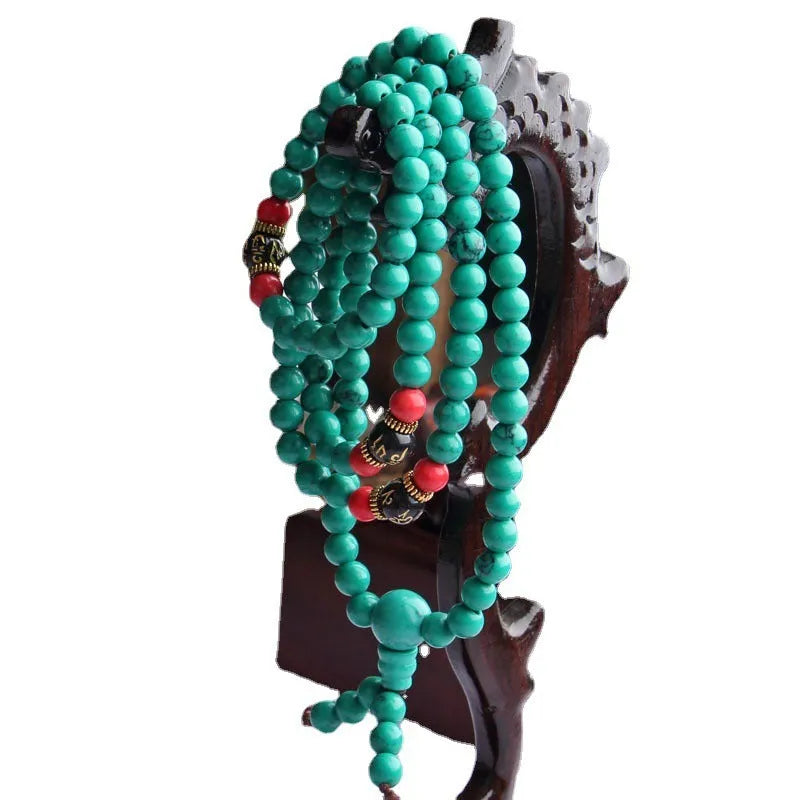 Turquoise Tibetan bracelet with 108 polished synthetic stone powder beads in traditional mala configuration
