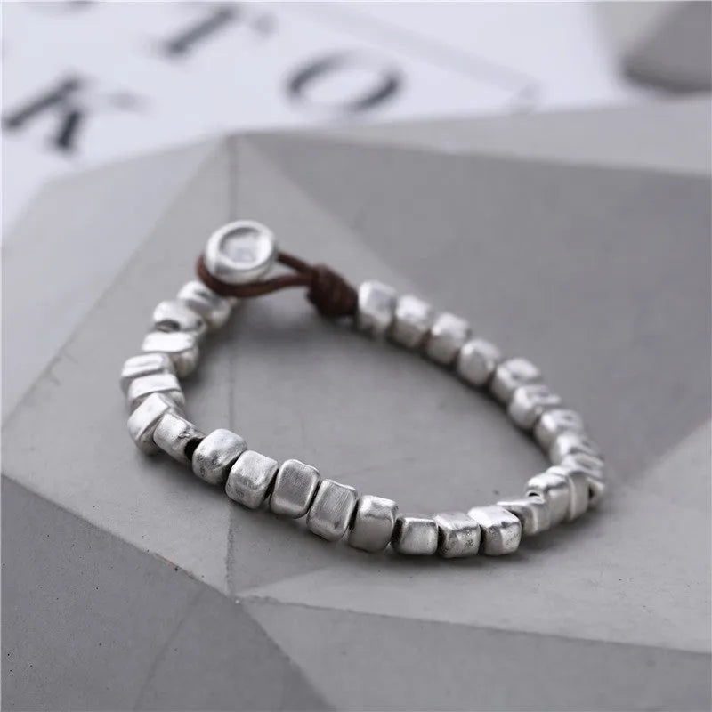 Handmade women's bracelet with silver squares and wooden beads on elastic cord