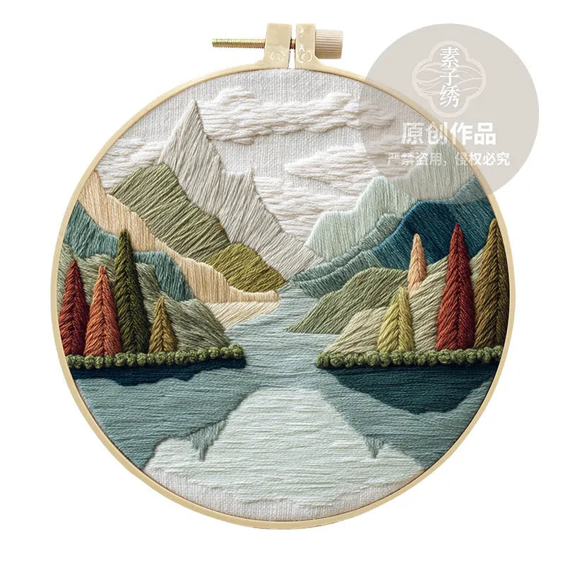 Embroidery DIY kit with cotton linen fabric, bamboo hoop, threads, and needles for landscape designs.