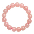 Pink crystal barrel bead bracelet with geometric design and polished finish