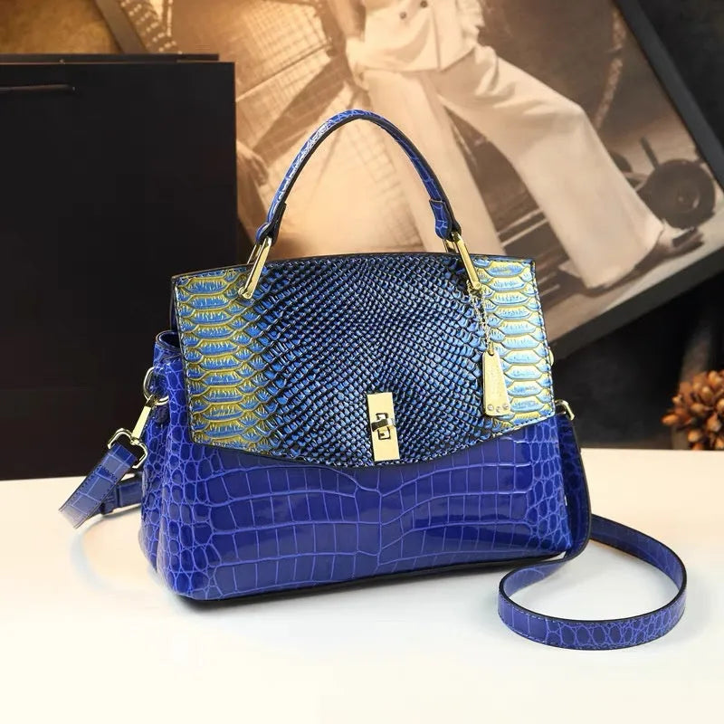 Colourful women's crossbody bag with snake and crocodile pattern, showing double straps and horizontal square shape.