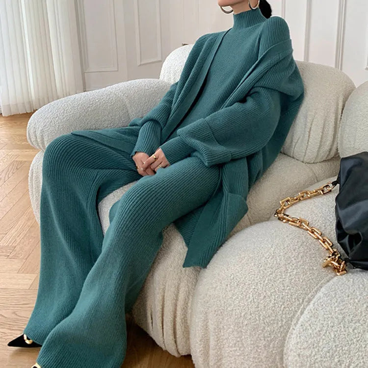 Women's apricot knitted wide-leg pants, sweater, and cardigan three-piece set with leather stitching detail.