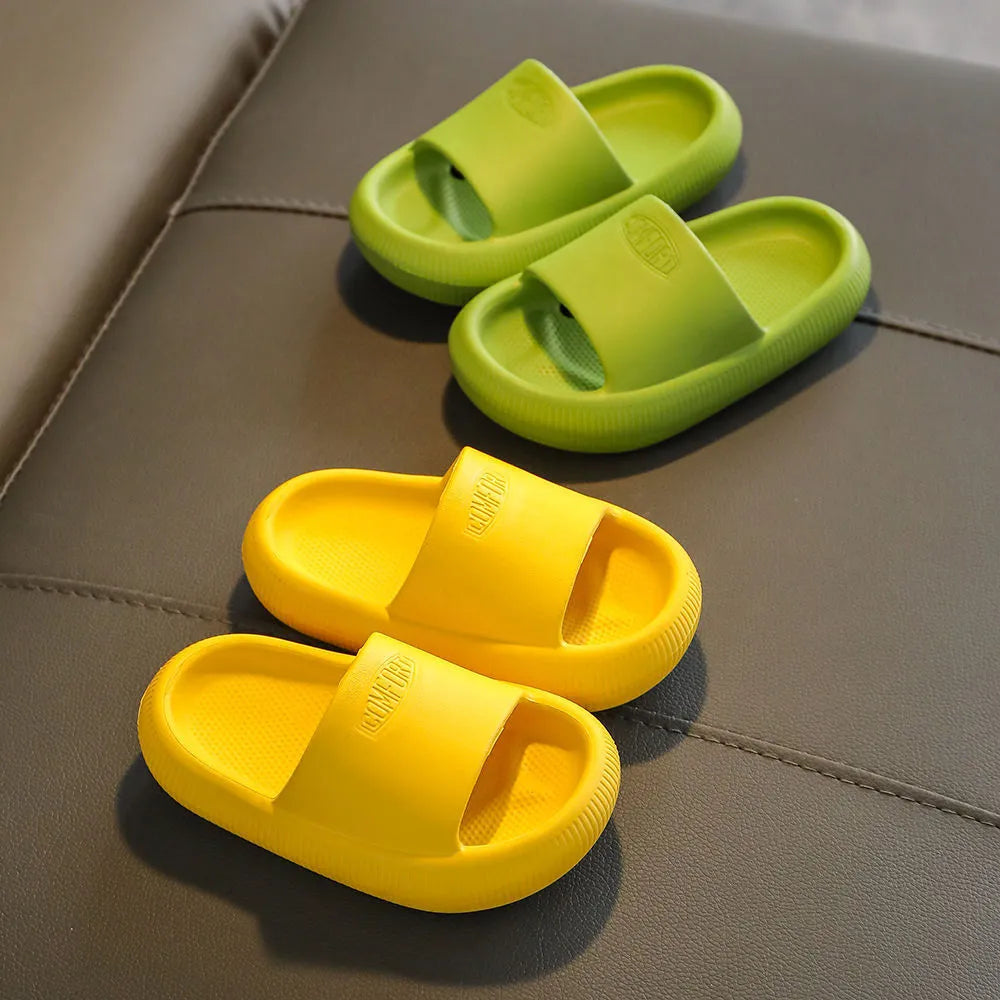 Colourful children's EVA slippers with a textured non-slip sole, shown in blue, green, orange, pink, and yellow.