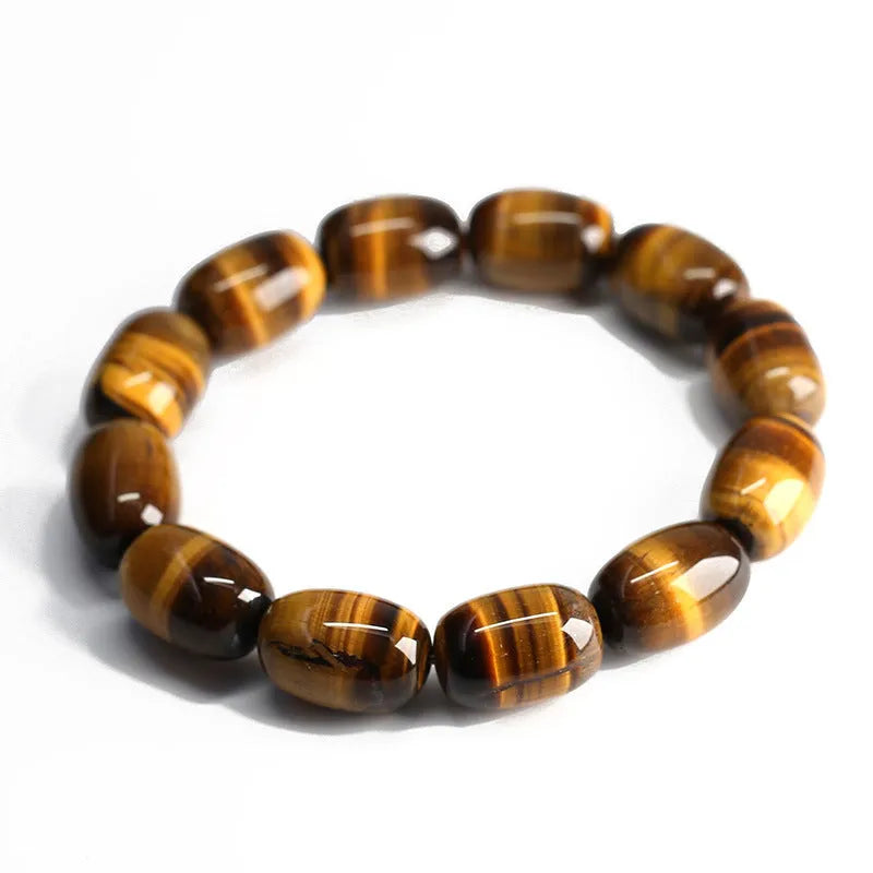 Yellow Tiger's Eye gemstone beaded bracelet with ethnic styling on a wrist.