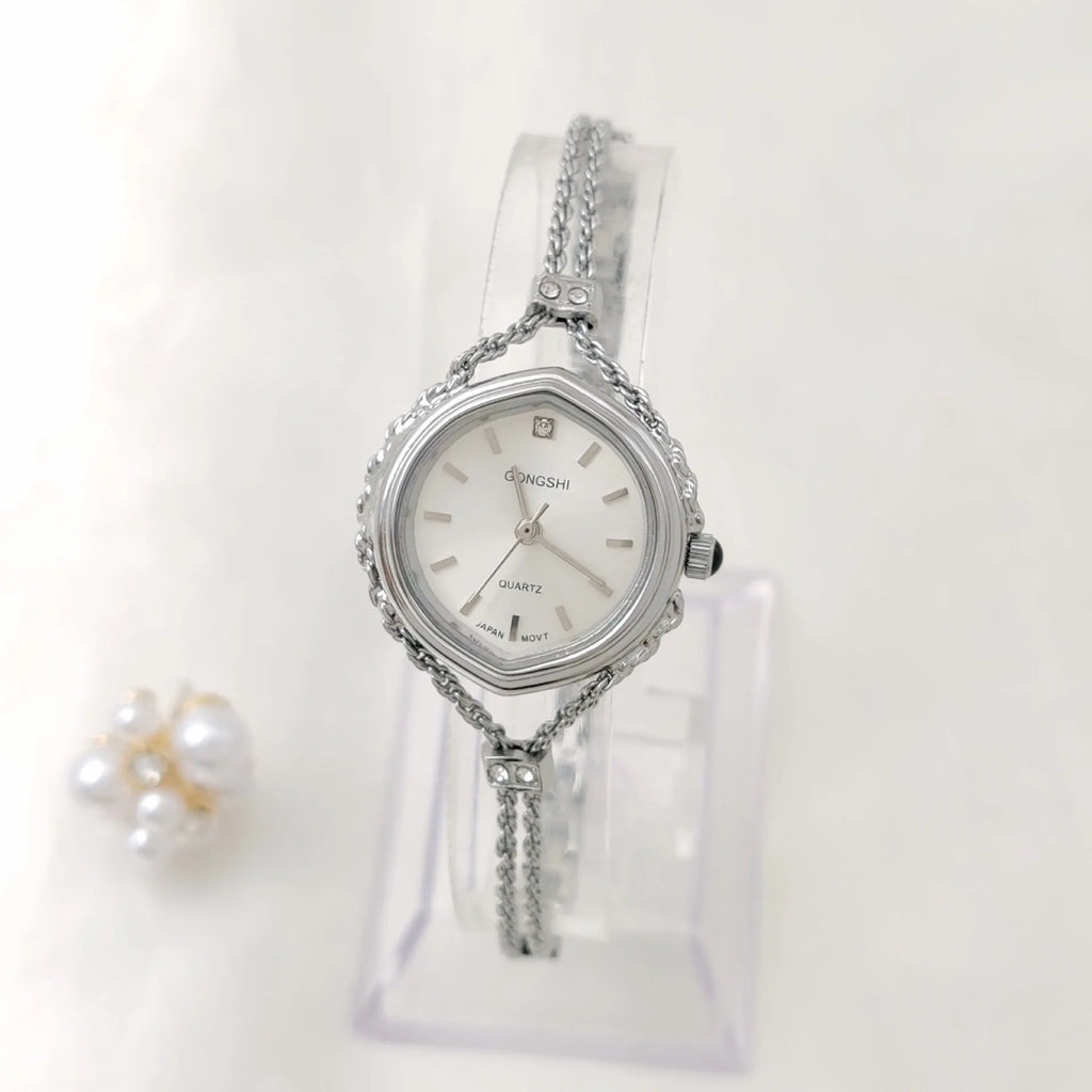 Women's Mori style quartz watch in gold or silver with a 25mm dial and chain strap.