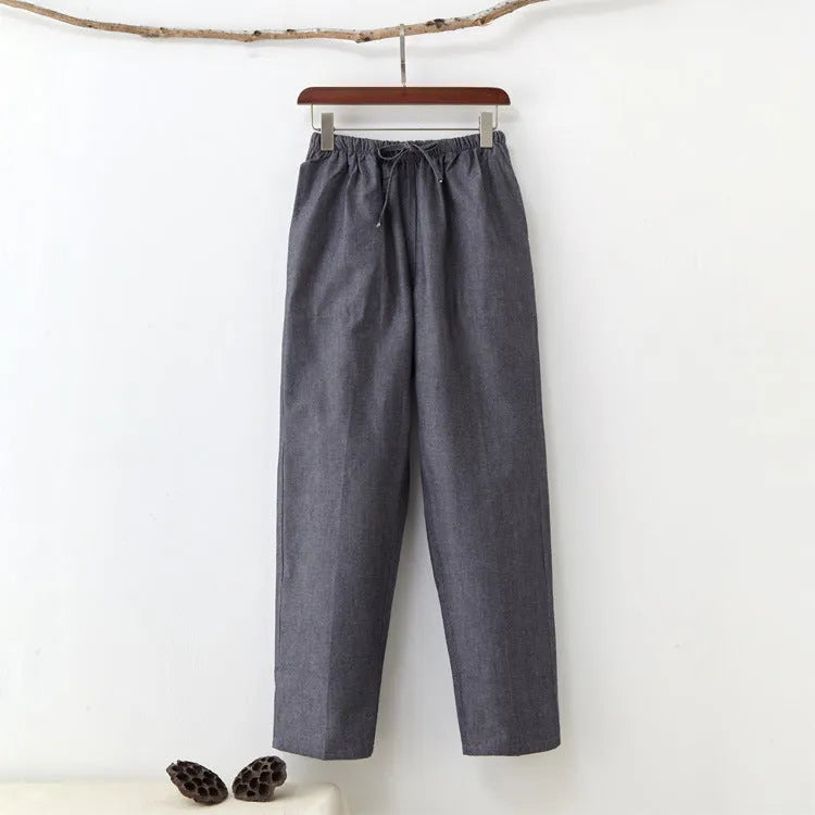 Men's beige pure cotton casual trousers with a drawstring waist on a hanger.