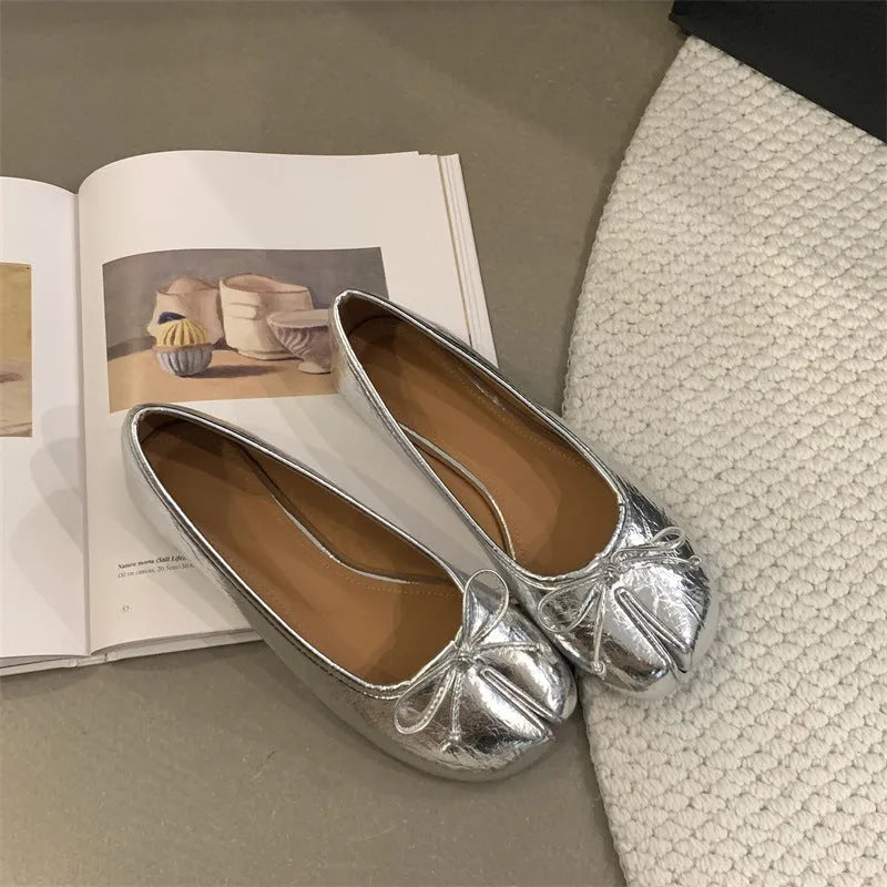 Women's flat split-toe pumps in black, silver, beige, and red with an oversleeve design.