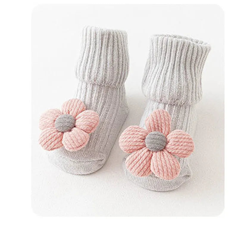 Cotton baby socks in multiple colours and designs including a panda pattern and a blue bow.