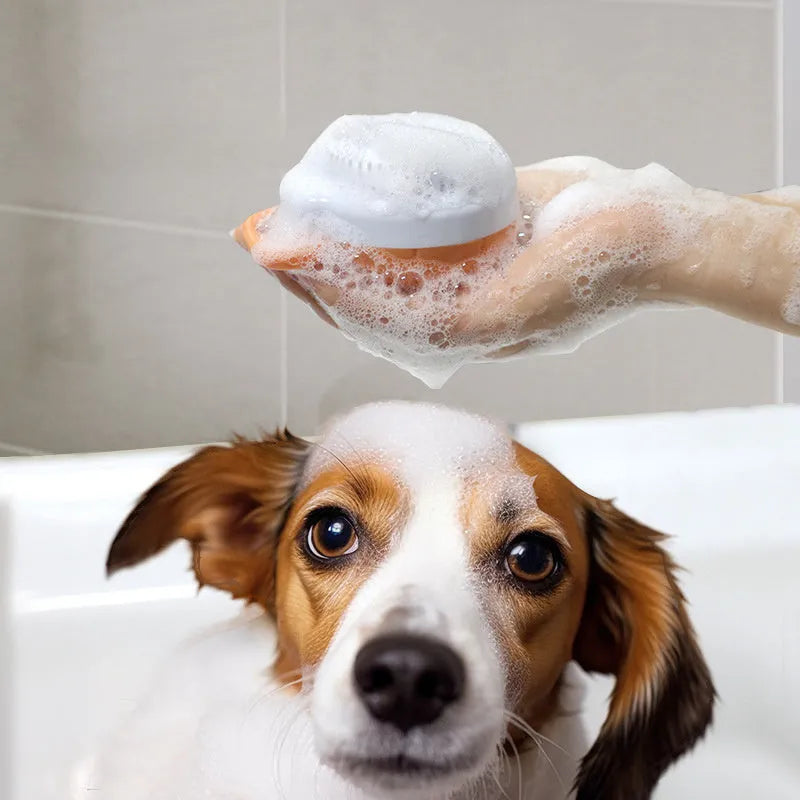 Orange silicone dog bath brush with shampoo dispenser and massage bristles for pet grooming