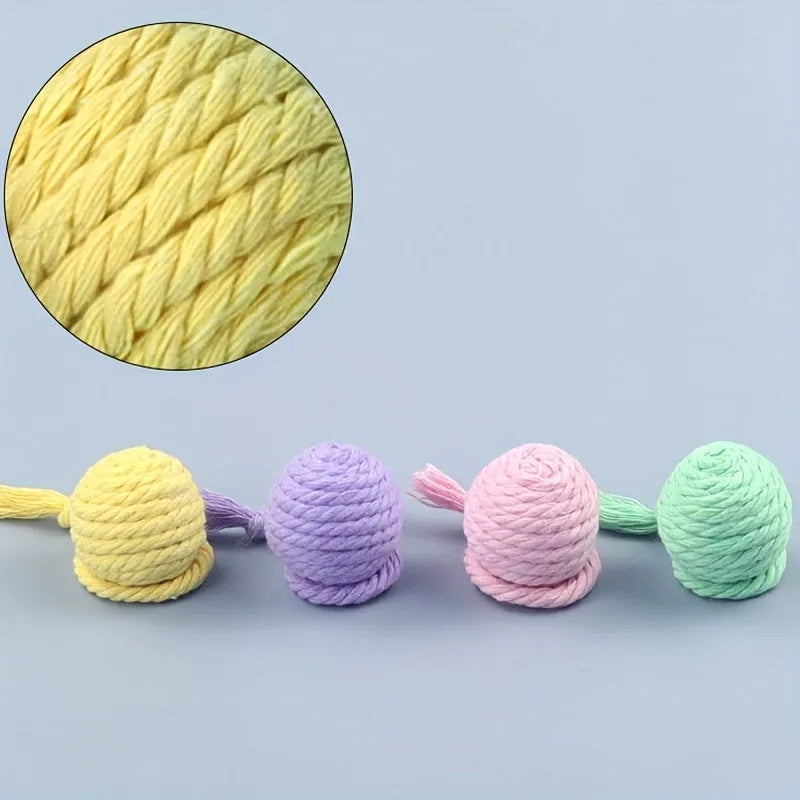 Fabric cat toy ball with rope attached in green, pink, purple, or yellow colours