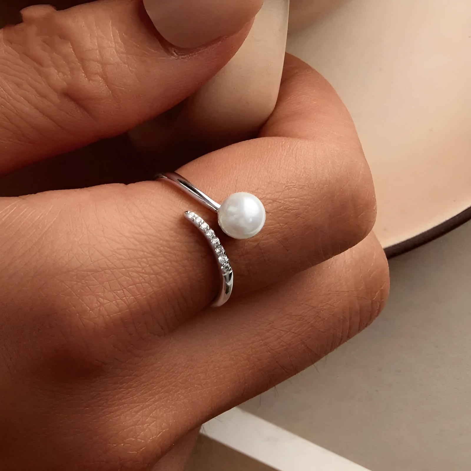 S925 sterling silver adjustable ring with shell pearl accents showing open loop design