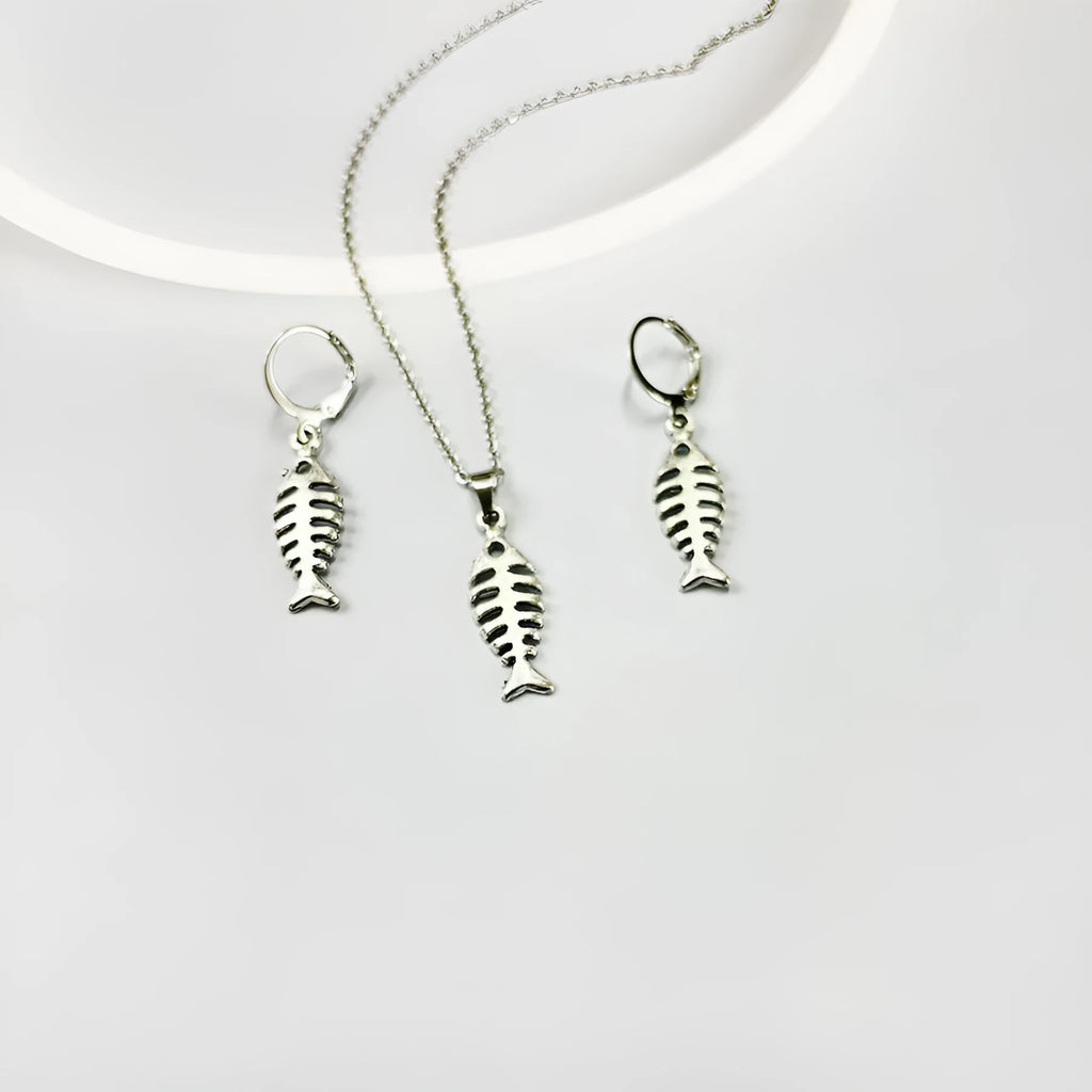 Women's fishbone pendant necklace and matching earrings set with adjustable chain on retro background